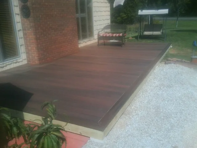 Freshly stained wood deck built against a brick home in Burbank